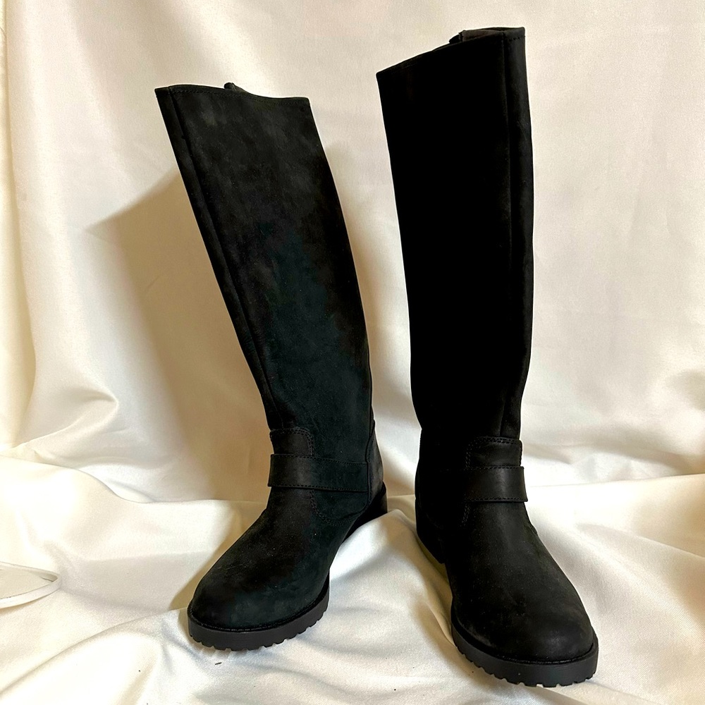 New. Unworn. Size 6, knee high leather riding boots in black.